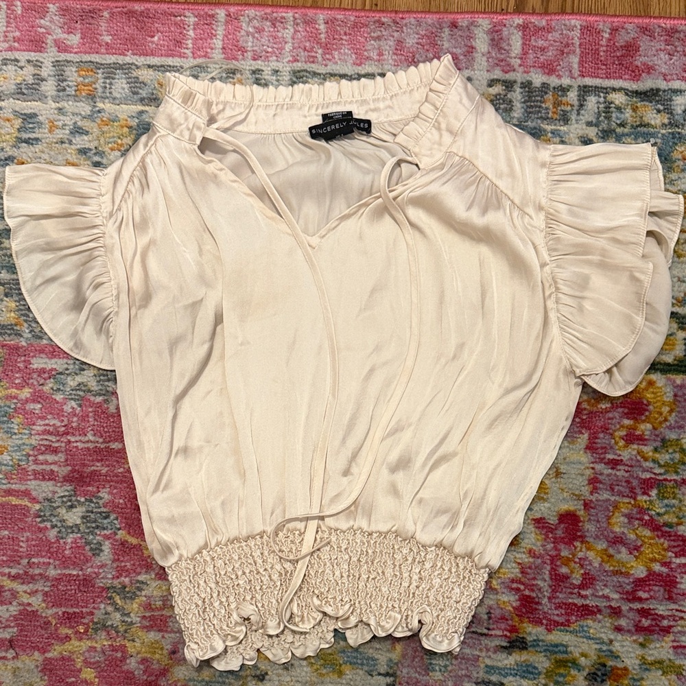 Sincerely Jules Cropped Cream Ruffle Blouse. Small tiny tan stain on front